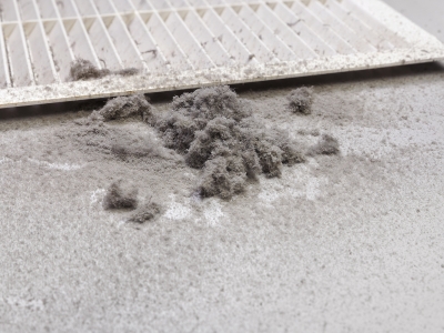 Dust accumulation around air duct filter, indicating potential air duct issues and the need for professional HVAC maintenance.